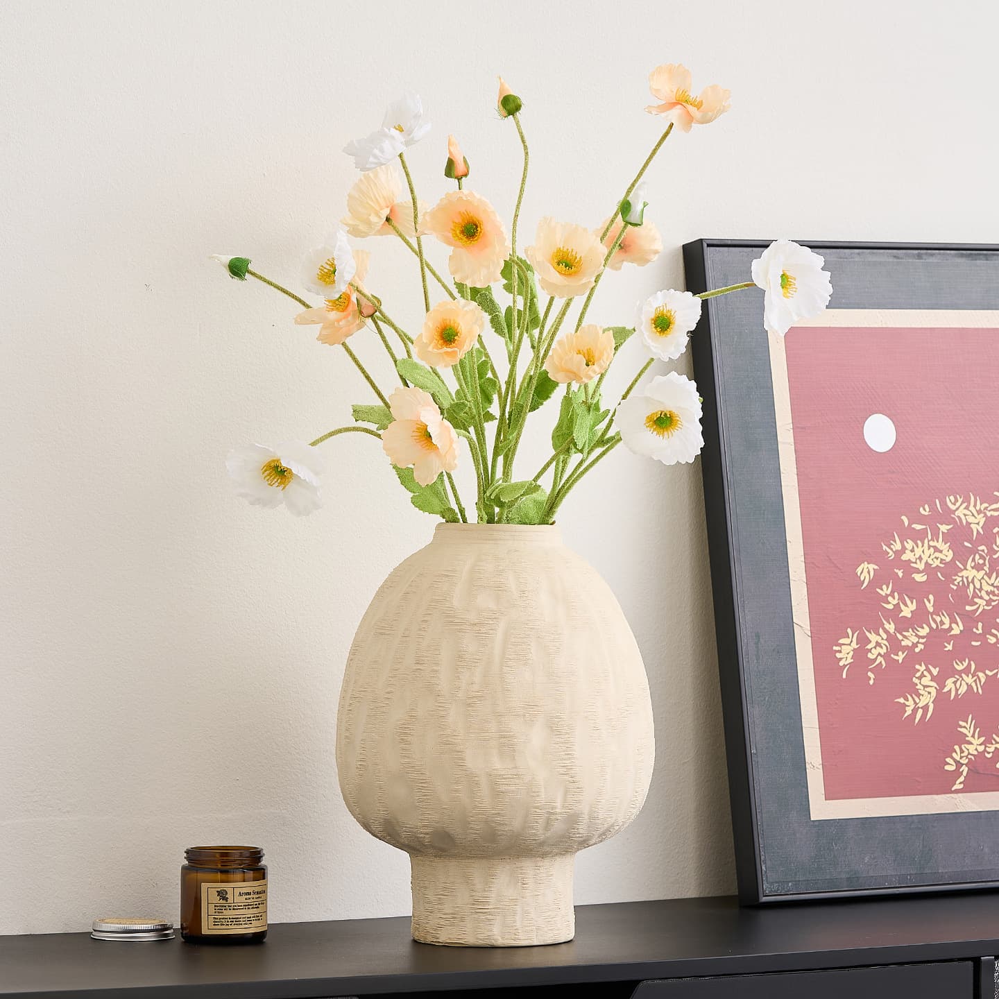 Ivory ceramic vase styled with pale flowers